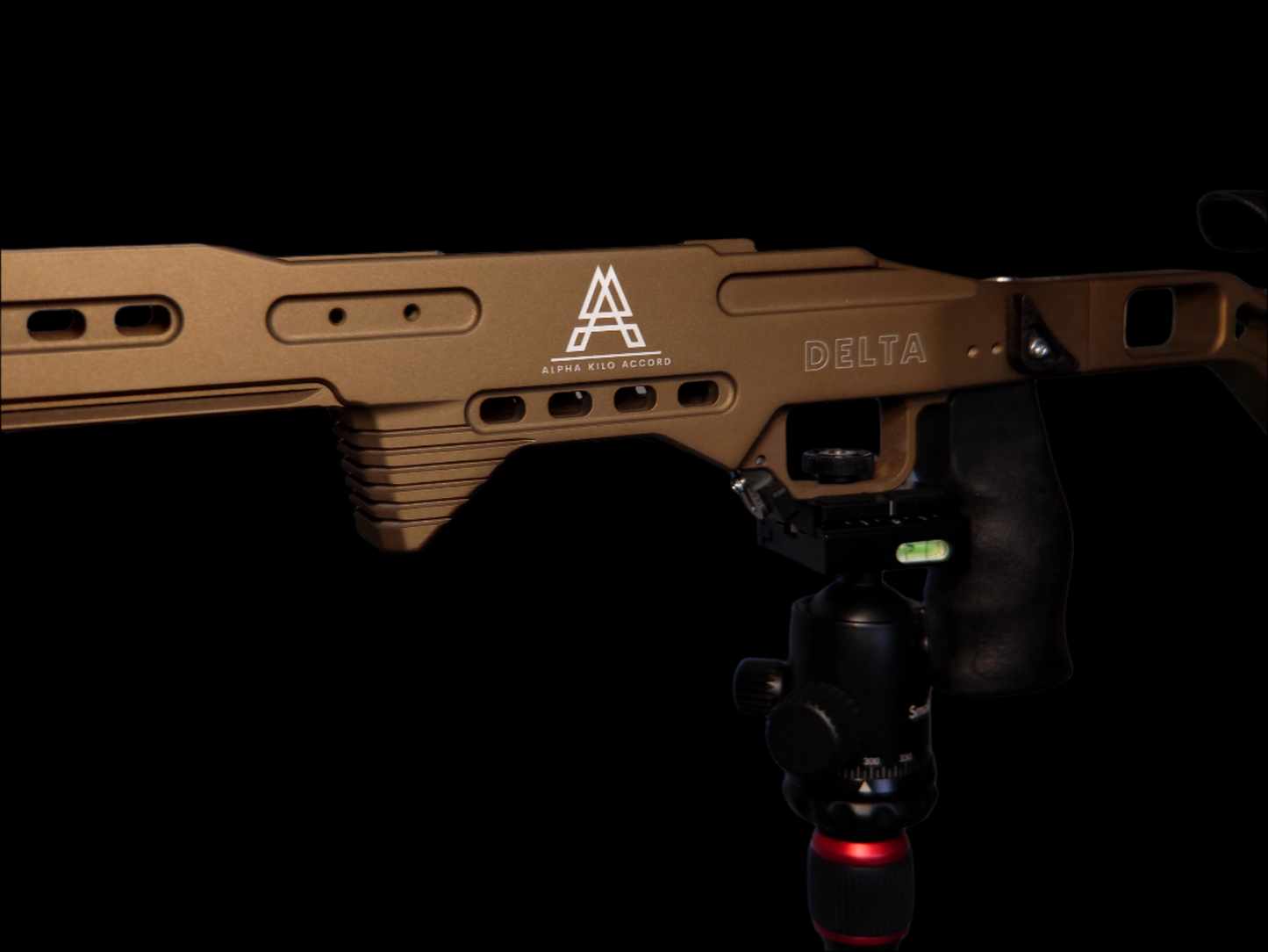 Close-up of the Delta Chassis in Burnt Bronze, featuring an ergonomic textured grip and precision-machined details for durability